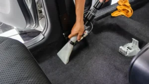 車内フロアを洗浄機で清掃している作業イメージ