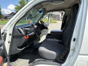 同じ運転席まわりを、作業のあとに助手席側から撮ったもの。木目調のダッシュボードとハンドル